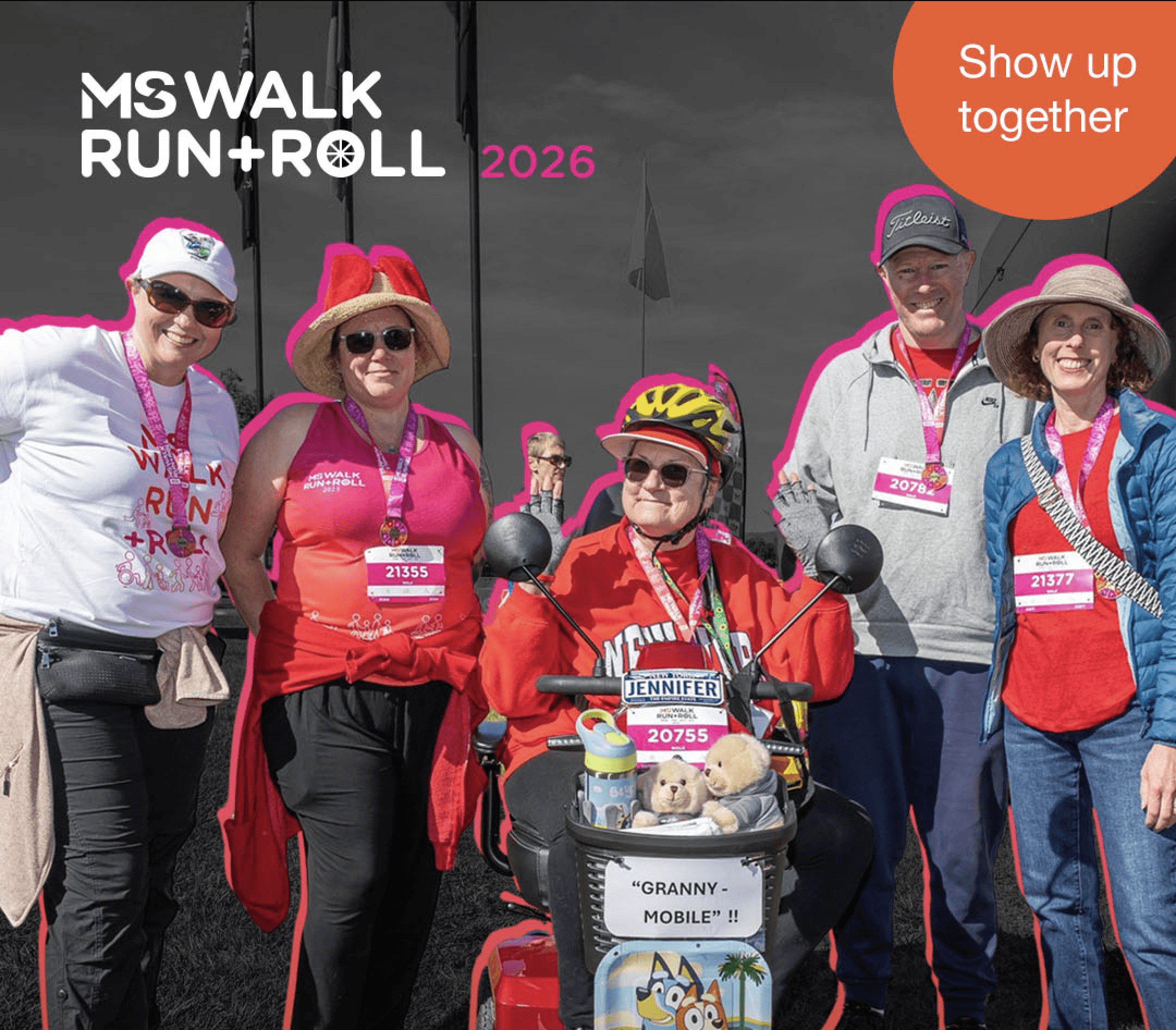 Group of people dressed up in fancy dress standing together smiling at the Walk Run Roll event
