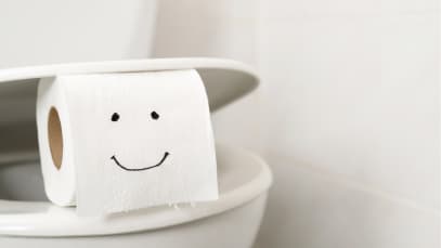 A toilet roll with a smiling face drawn on