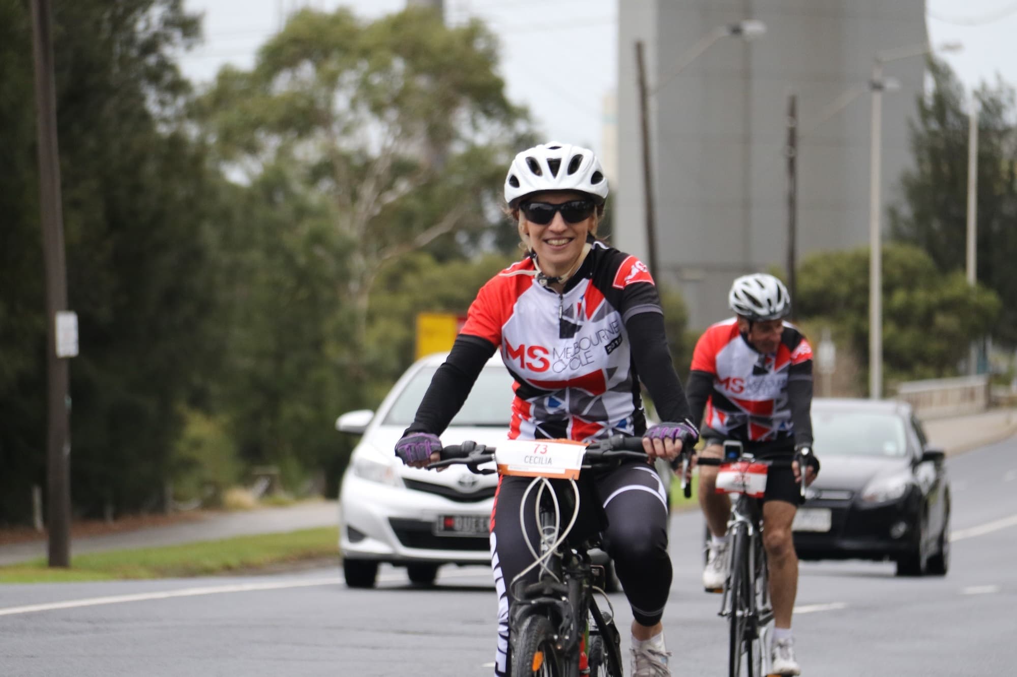Two bikers riding bike wearing jackets of Melbourne Cycle Club