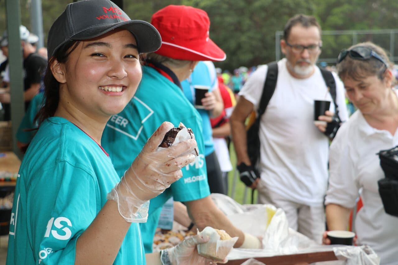 Two MS club Volunteers addressing the crowd at counter