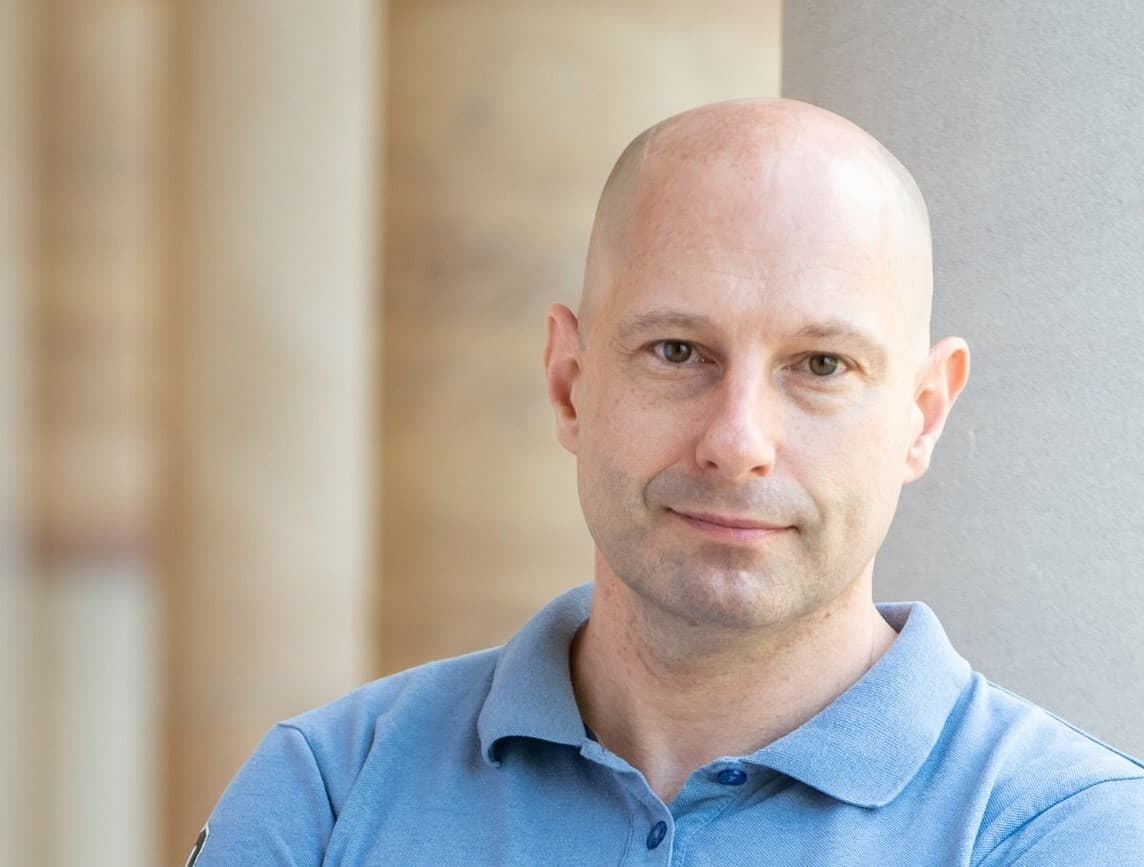 Dr lachlan rash stands outside c