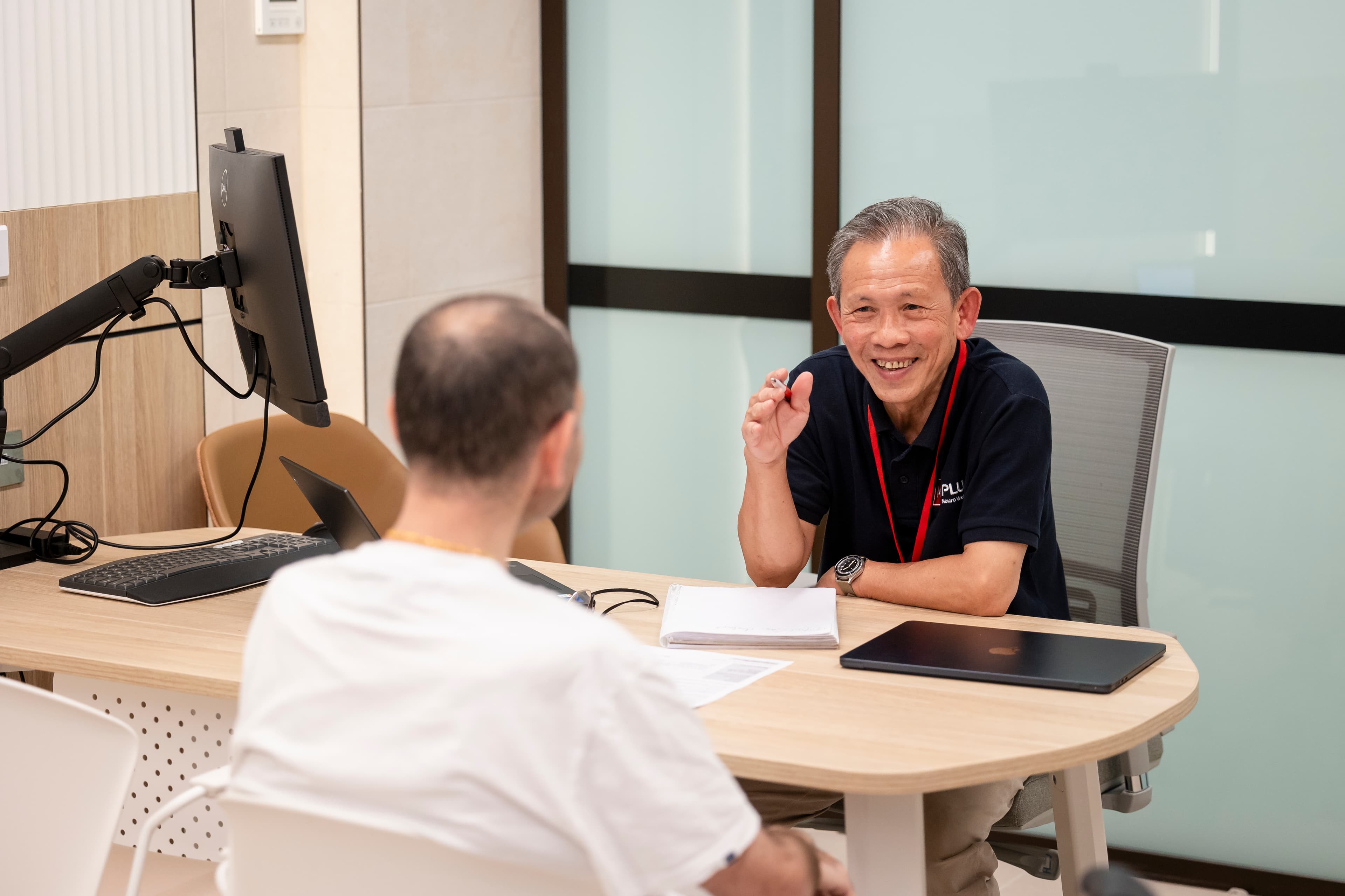 MS plus staff having conversation with another individual