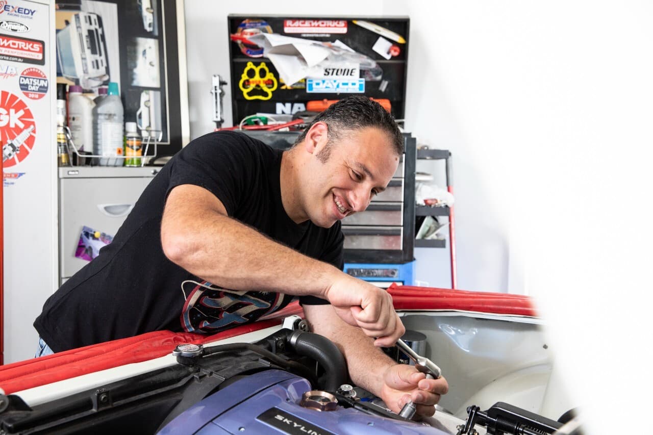 A mechanic working on a car.