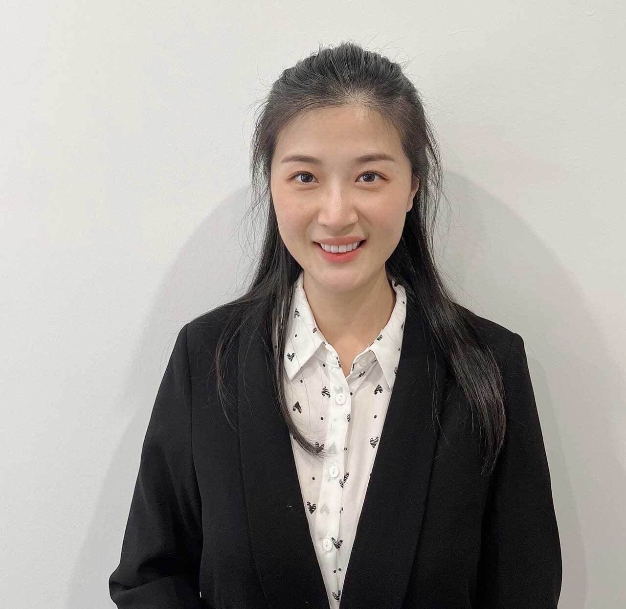 Christine Qin standing against a white background