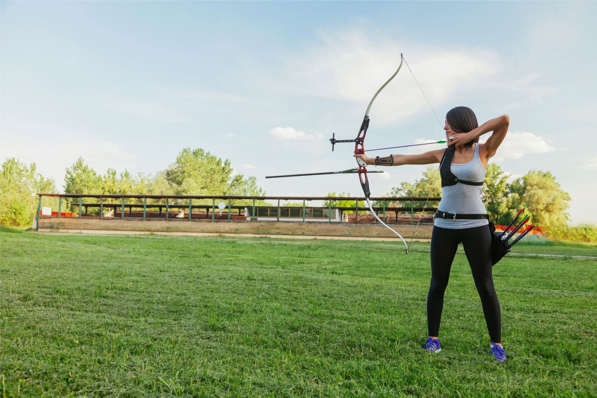 Bec, an MS warrior, holding a bow and drawing an arrow