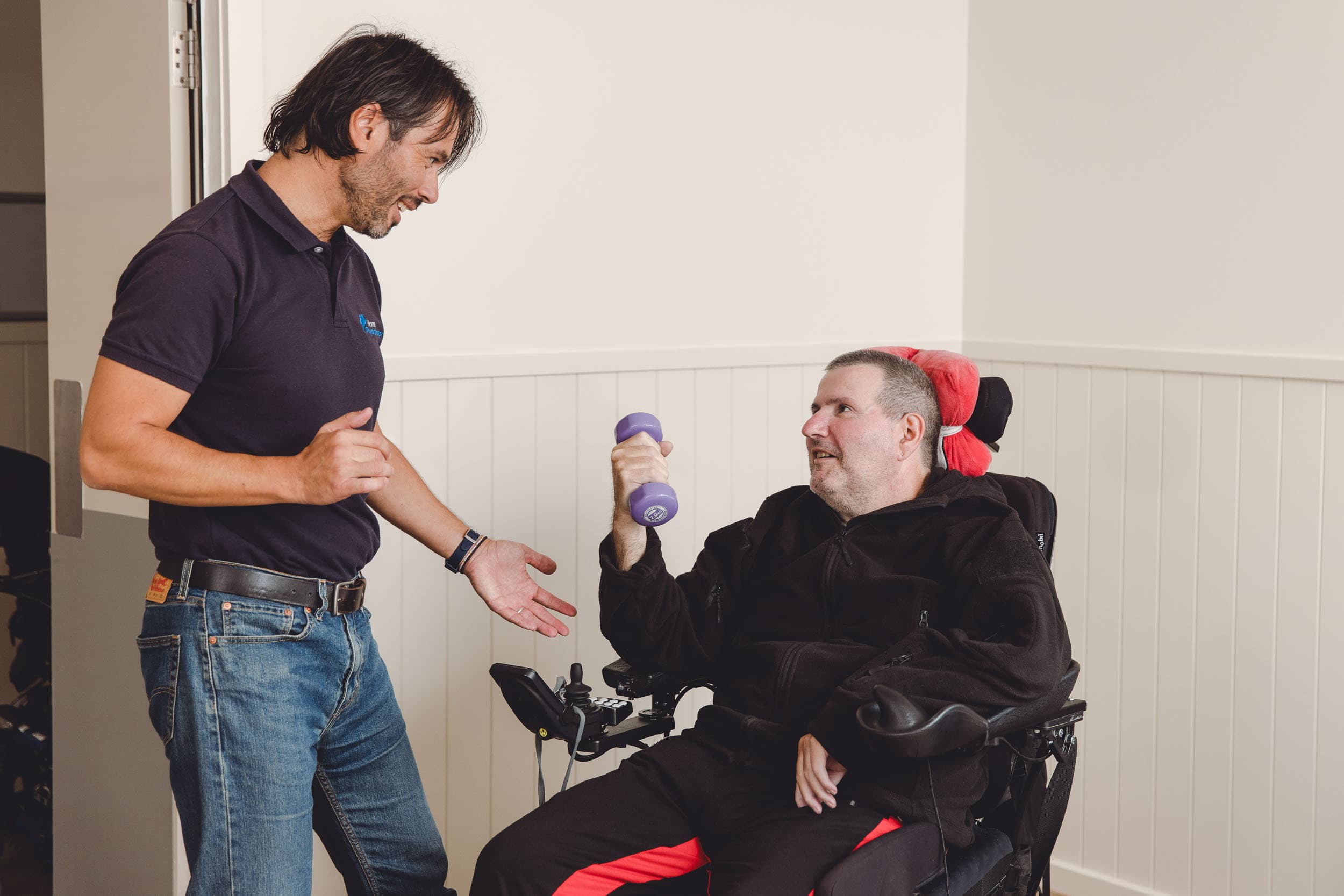 Resident in Watsonia Home holding a purple weight
