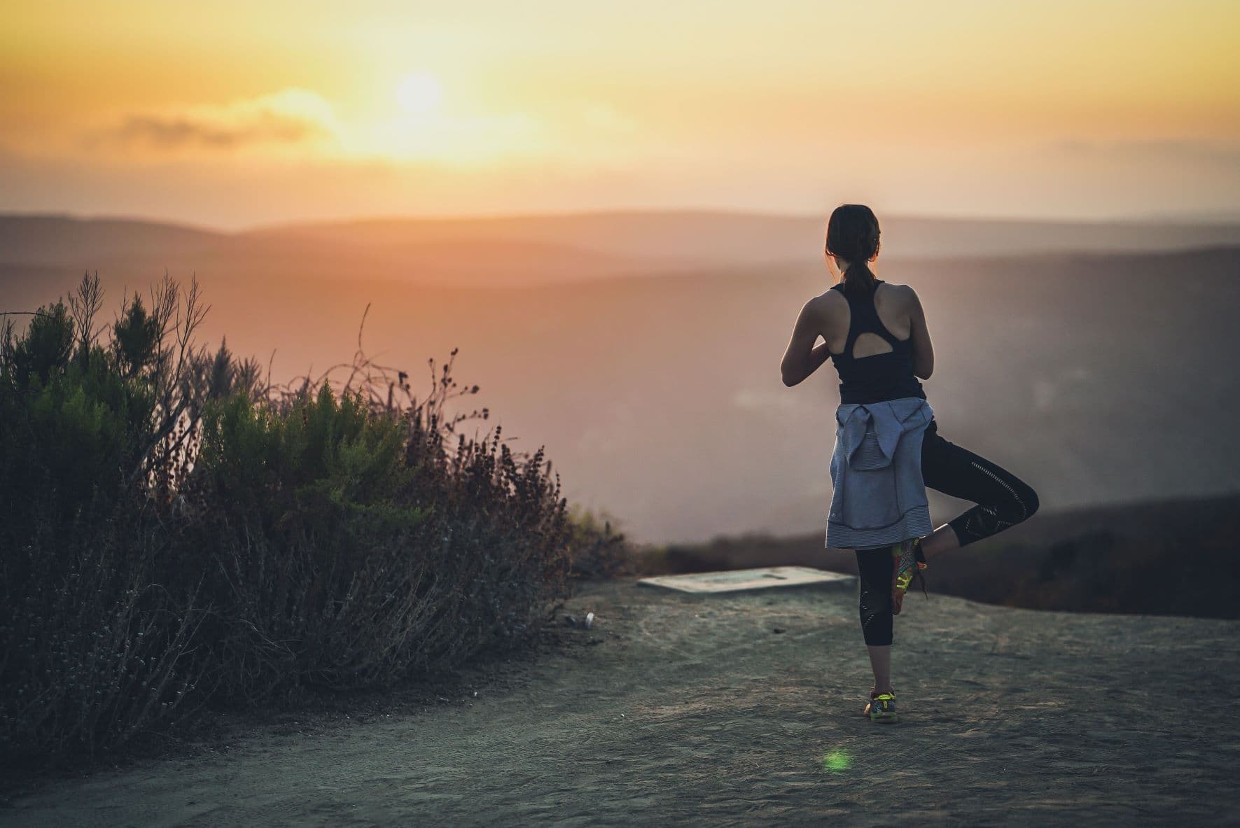 person doing yoga watching the sunset