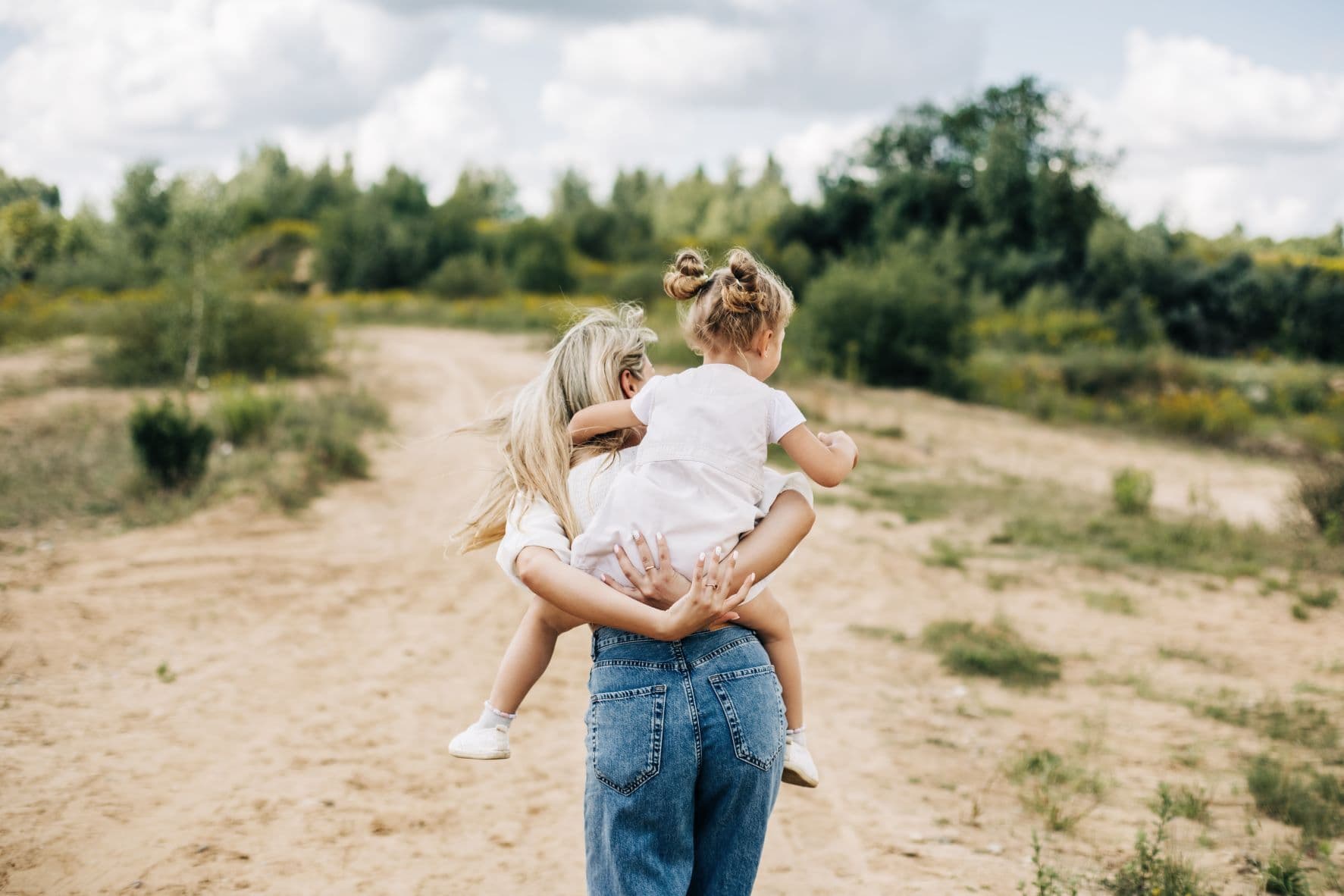 Parent with child on back outdoor setting