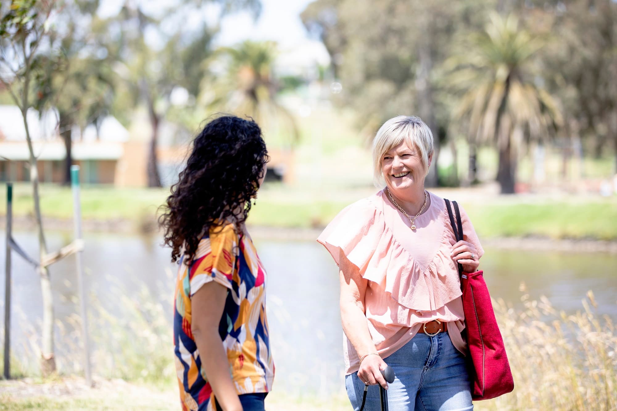 Two women walking and smiling