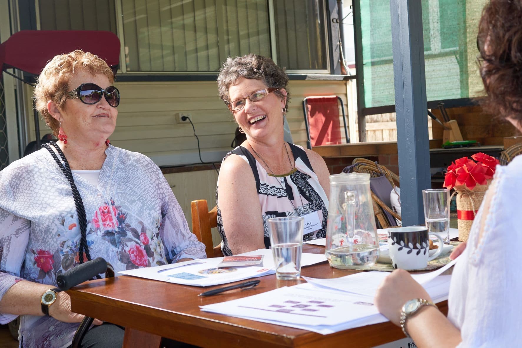 Lisa sits at a table with her peers