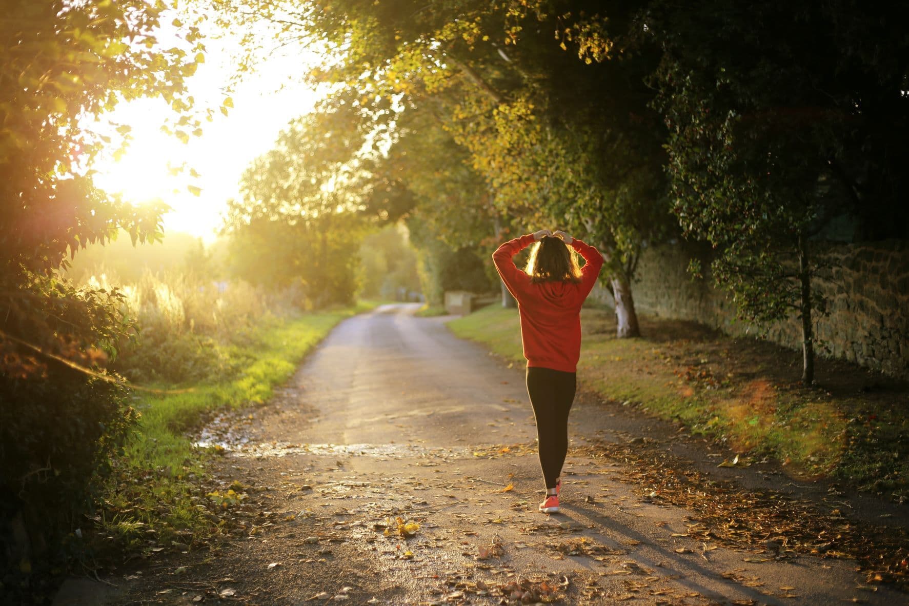 Person walking outdoors at sunset